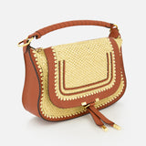 The Marcie Raffia Effect Shoulder Bag by CHLOÉ features brown leather, a gold woven front flap, decorative stitching, padded handle, twin tassels, and curved structured shape—perfect for elevating your everyday style.