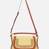The Marcie Raffia Effect Shoulder Bag by CHLOÉ features brown leather accents, a flap closure, decorative stitching, and a long adjustable strap, shown against a plain white background.