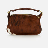 CHLOÉ Marcie Calf Hair Bag featuring a brown and white cow print, a curved, wrapped handle, and gold-tone hardware.