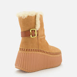 The Nama Suede and Shearling Boots by CHLOÉ feature tan suede, a thick ridged light brown platform sole, gold buckle detail, and cozy shearling lining, shown from the back on a white background.