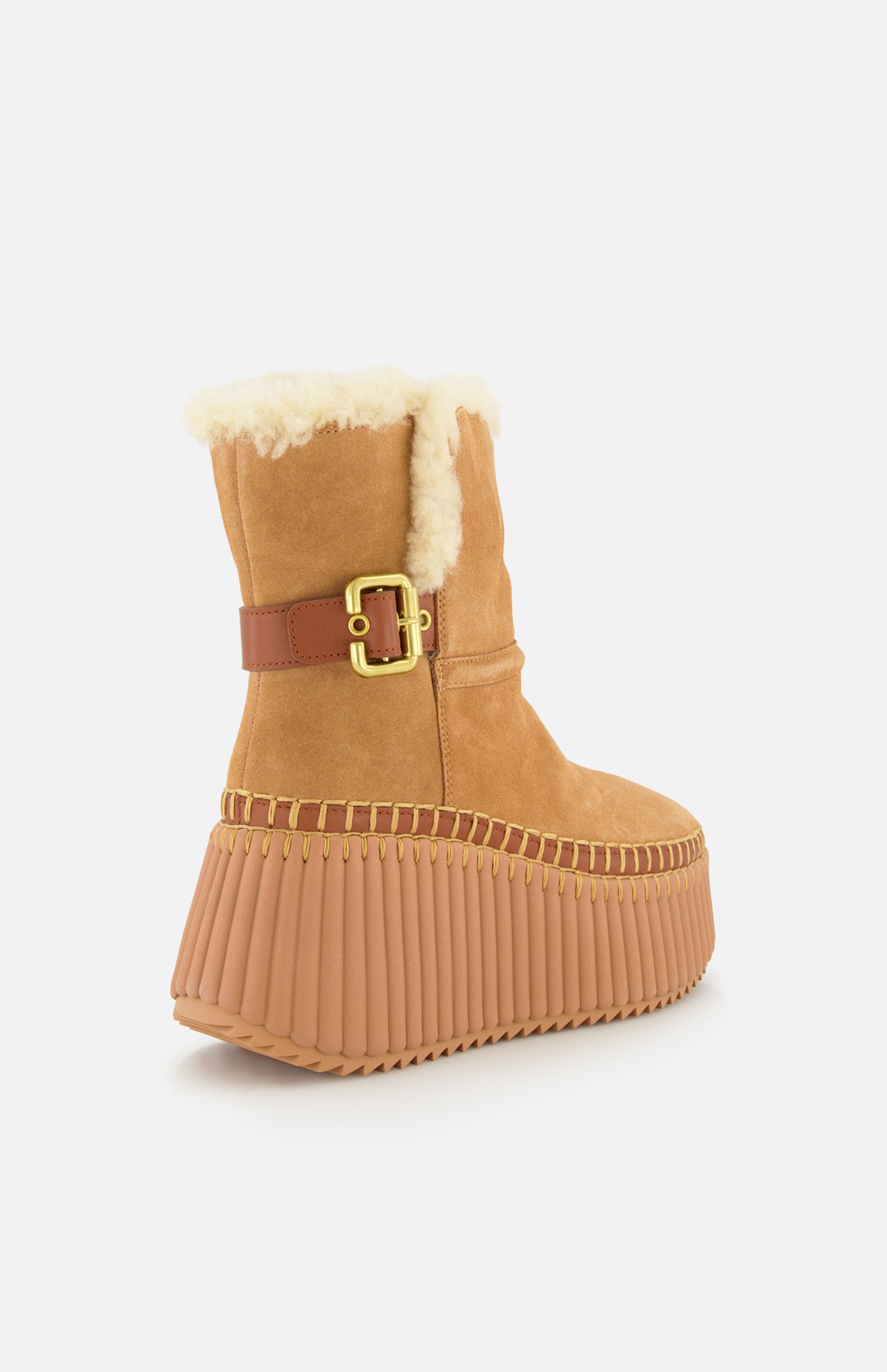 The Nama Suede and Shearling Boots by CHLOÉ feature tan suede, a thick ridged light brown platform sole, gold buckle detail, and cozy shearling lining, shown from the back on a white background.