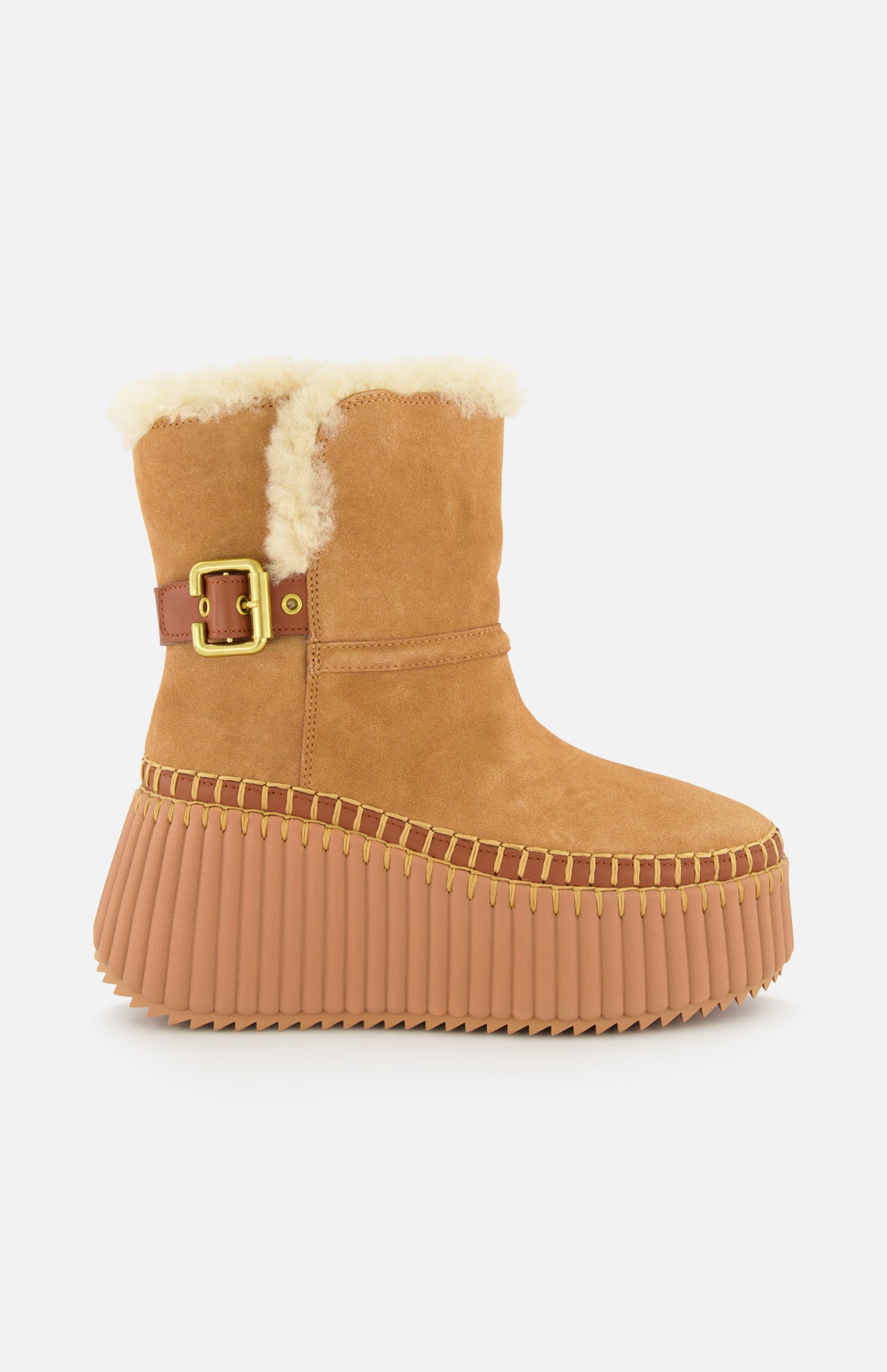 CHLOÉ Nama Suede and Shearling Boots feature tan suede, shearling lining, a gold buckle strap, thick ridged rubber soles, and detailed stitching for a cozy winter style.