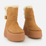 Nama Suede and Shearling Boots by CHLOÉ in tan suede with shearling lining, chunky rubber platform soles, stitched details, and a side buckle, shown on a white background.