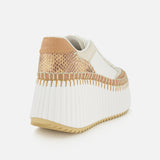 The CHLOÉ Nama Wedge Sneaker features a chic leather design with a thick ribbed white platform sole, beige and tan accents, and visible stitching, showcased from the back left against a white background.