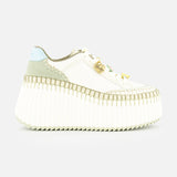 The CHLOÉ Nama Charm Detail Sneaker features a white platform and recycled sole, with light green and blue suede accents, detailed stitching, and gold hardware on the laces. Shown against a plain white background.