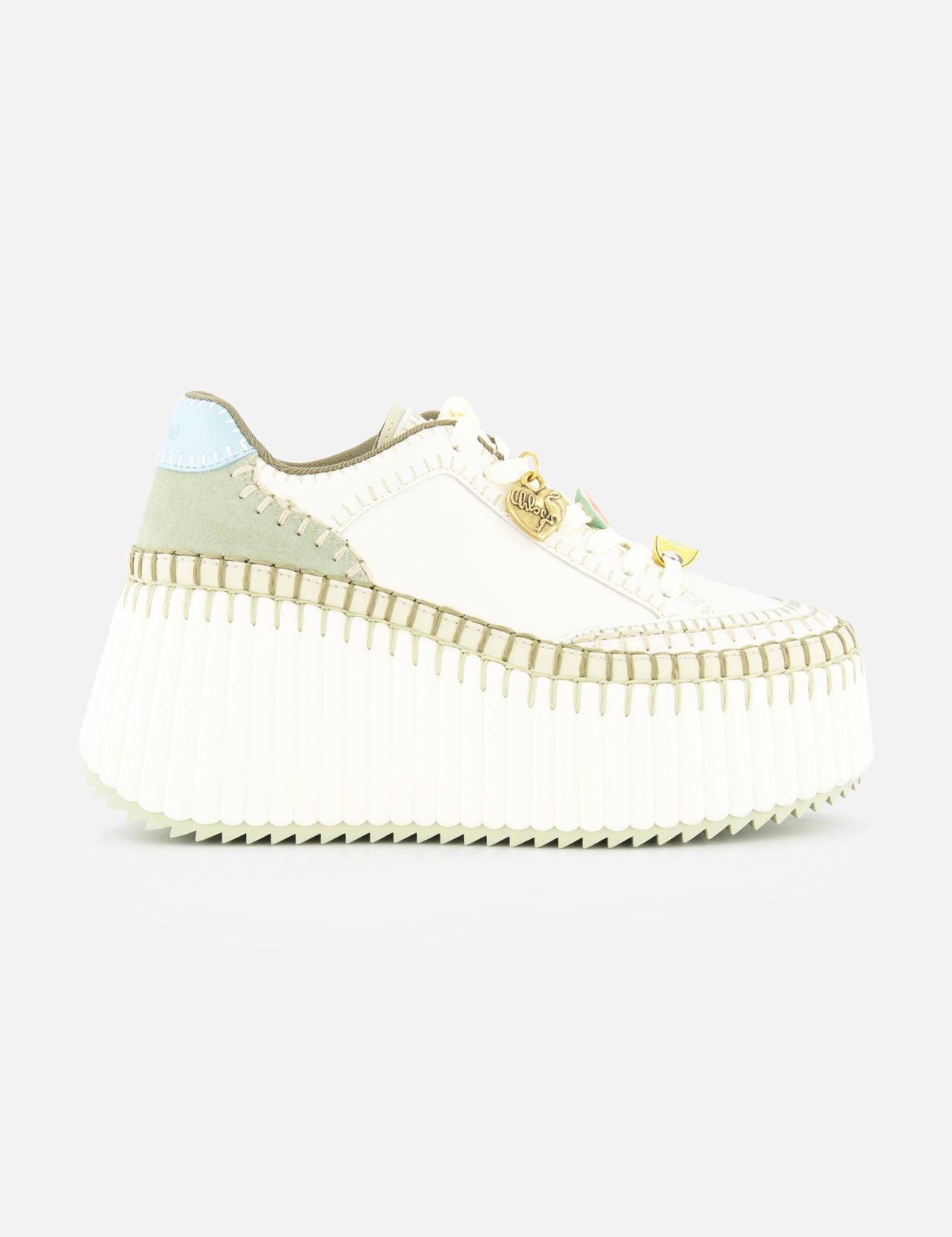 The CHLOÉ Nama Charm Detail Sneaker features a white platform and recycled sole, with light green and blue suede accents, detailed stitching, and gold hardware on the laces. Shown against a plain white background.
