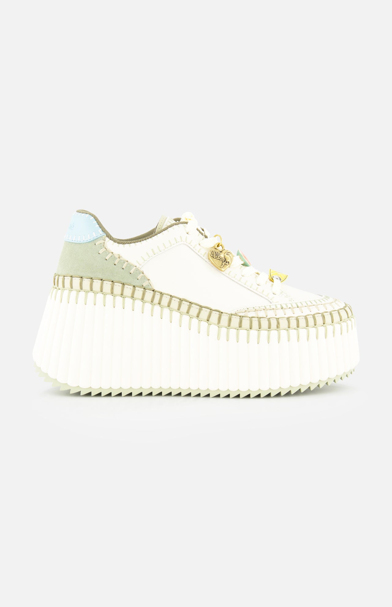 The CHLOÉ Nama Charm Detail Sneaker features a white platform and recycled sole, with light green and blue suede accents, detailed stitching, and gold hardware on the laces. Shown against a plain white background.