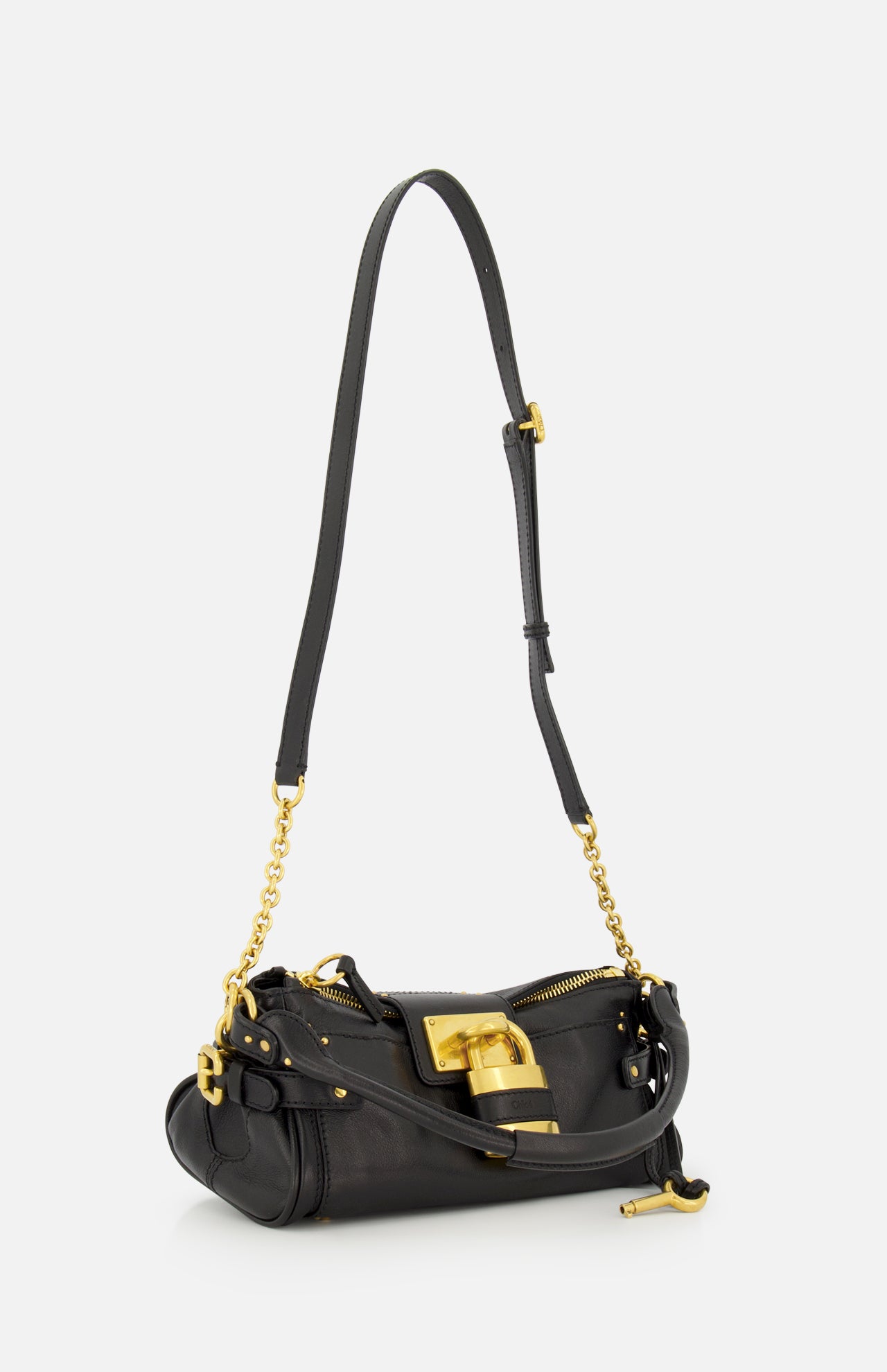 Standing upright against a plain white background, the CHLOÉ Paddington Removable Strap Shoulder Bag features black leather with a gold chain strap, gold zipper, and a prominent oversized padlock detail on the front—a nod to the iconic Paddington bag.