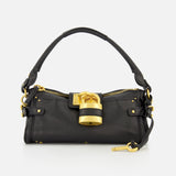 The CHLOÉ Paddington Removable Strap Shoulder Bag features black leather, a short handle, gold hardware, and an oversized padlock accent on the front. A small gold key hangs from one side of the bag. The background is plain white.