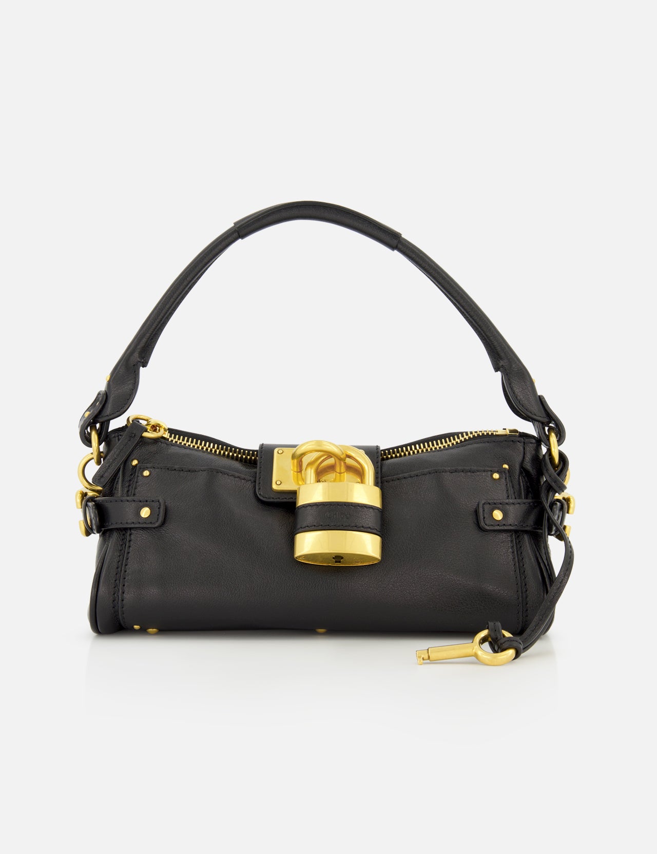 The CHLOÉ Paddington Removable Strap Shoulder Bag features black leather, a short handle, gold hardware, and an oversized padlock accent on the front. A small gold key hangs from one side of the bag. The background is plain white.