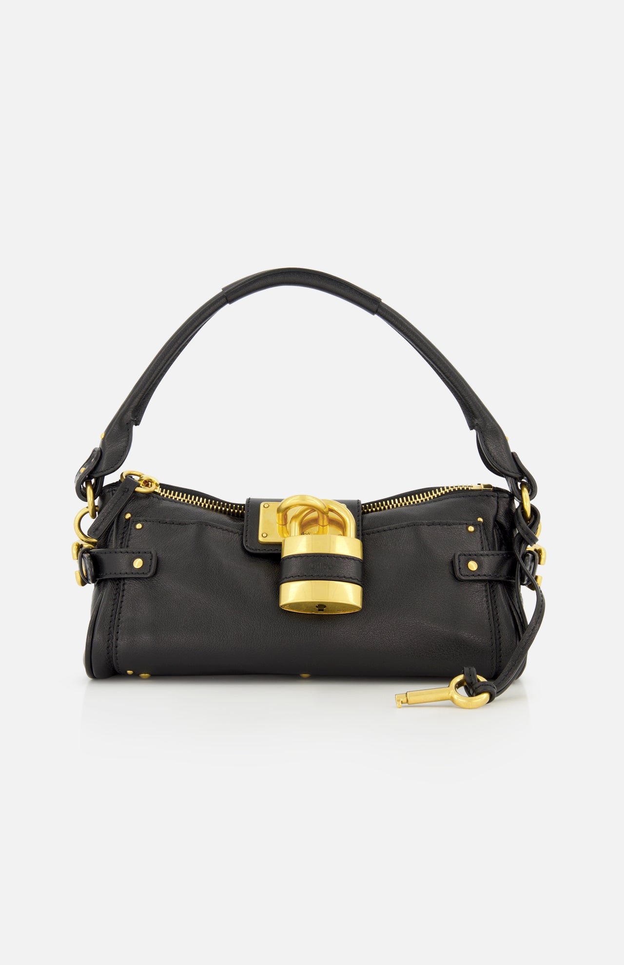 The CHLOÉ Paddington Removable Strap Shoulder Bag features black leather, a short handle, gold hardware, and an oversized padlock accent on the front. A small gold key hangs from one side of the bag. The background is plain white.