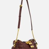 Introducing the CHLOÉ Paddington Shoulder Bag with Removable Strap—a designer handbag crafted from rich burgundy leather with dark brown leather detailing. This elegant shoulder bag features gold hardware, an adjustable and removable strap, and a signature large gold lock accent near the zipper, drawing inspiration from the iconic Paddington bag.