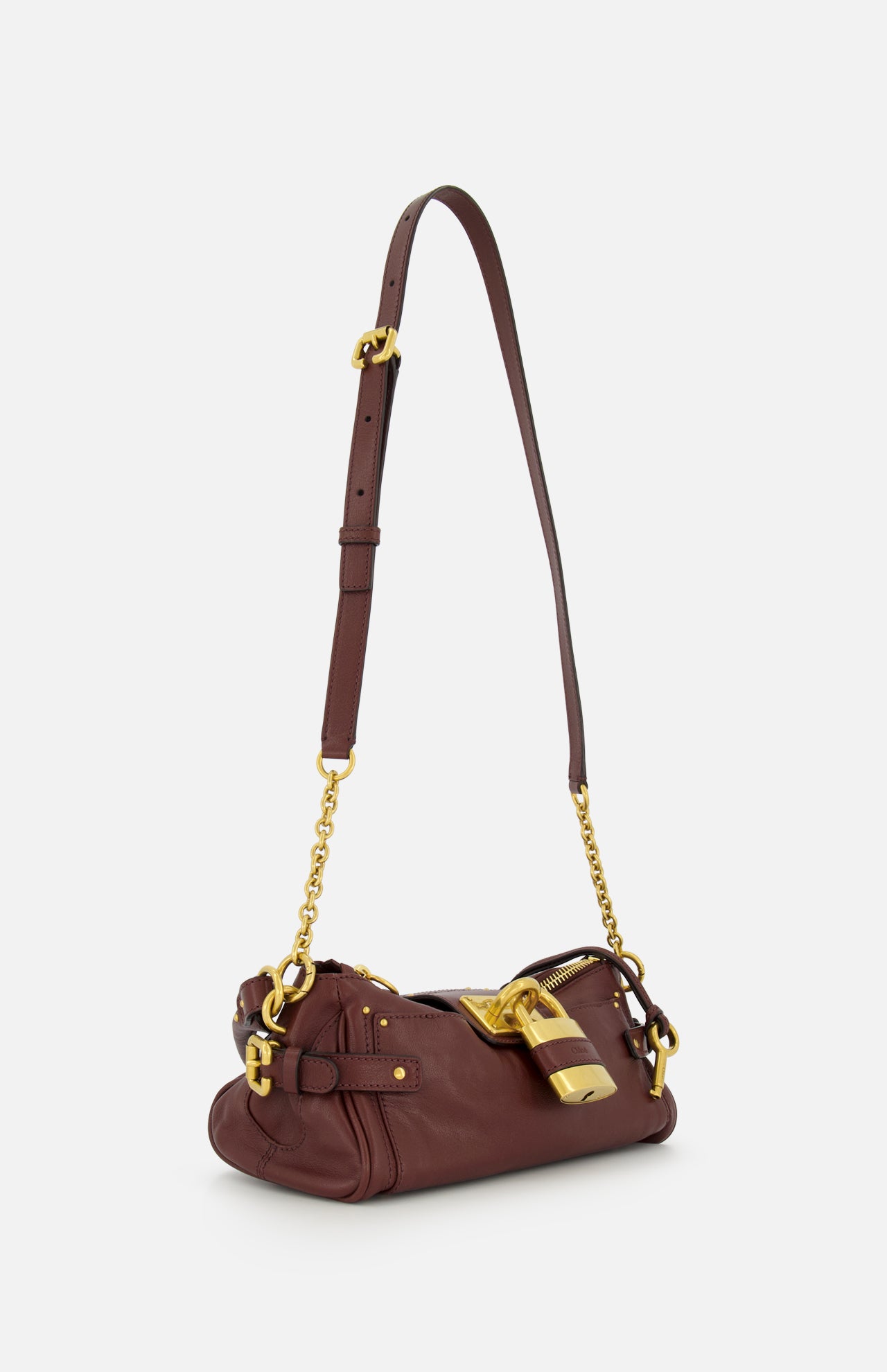 Introducing the CHLOÉ Paddington Shoulder Bag with Removable Strap—a designer handbag crafted from rich burgundy leather with dark brown leather detailing. This elegant shoulder bag features gold hardware, an adjustable and removable strap, and a signature large gold lock accent near the zipper, drawing inspiration from the iconic Paddington bag.