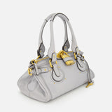 A CHLOÉ Paddington Shoulder Bag in light gray leather, featuring double handles, gold-tone hardware, and an oversized padlock on the front, displayed against a plain white background.