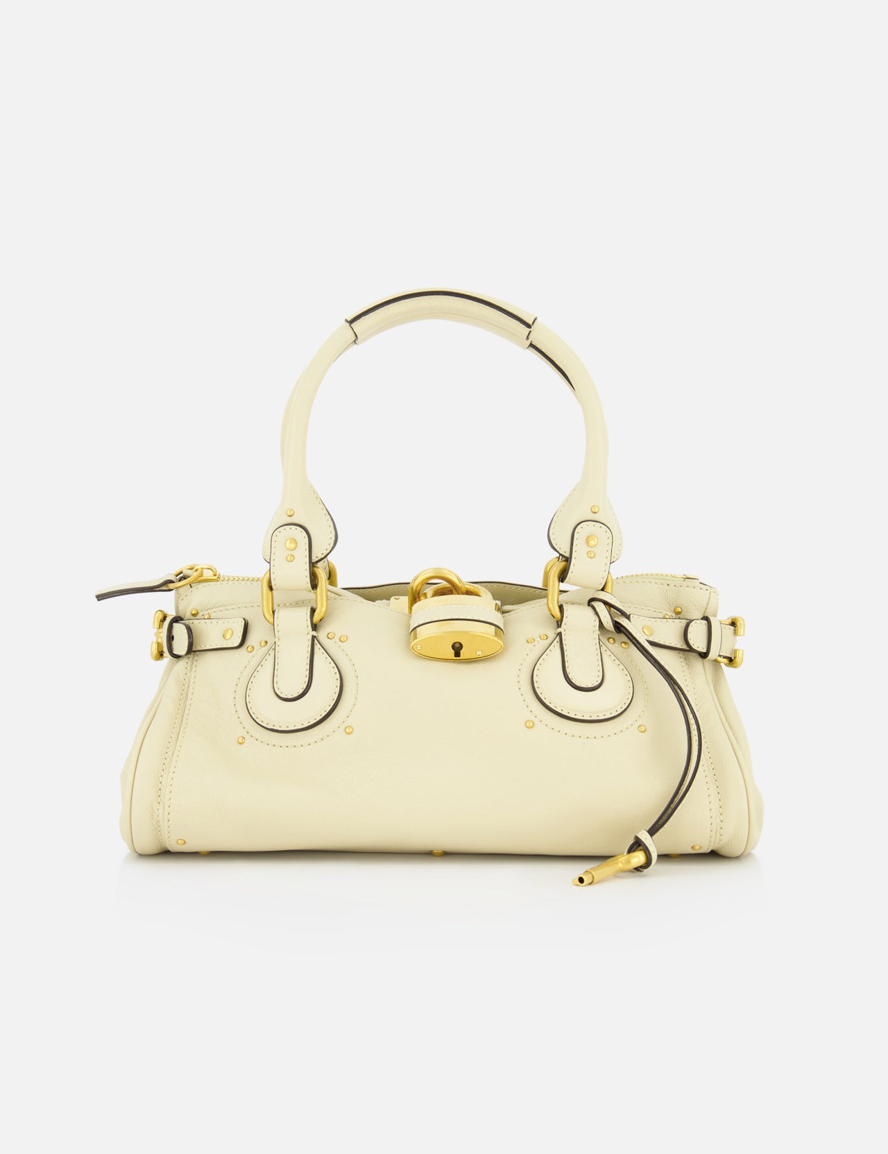 The CHLOÉ Paddington Shoulder Bag in cream grained buffalo leather features gold hardware, circular handles, a central oversized padlock, and a zipper pull detail, shown against a white background.
