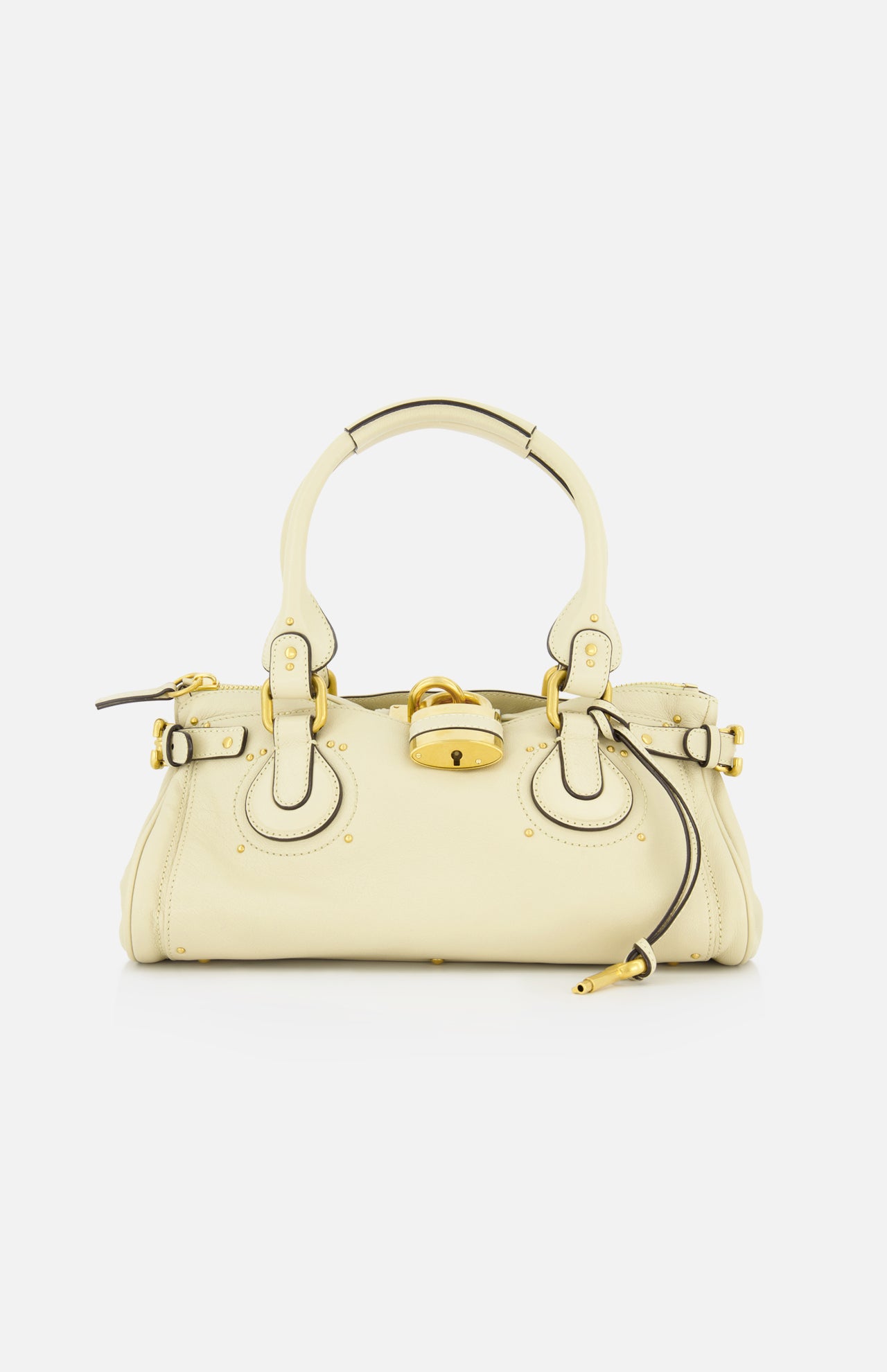 The CHLOÉ Paddington Shoulder Bag in cream grained buffalo leather features gold hardware, circular handles, a central oversized padlock, and a zipper pull detail, shown against a white background.