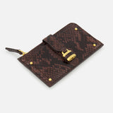 The CHLOÉ Python Paddington Wallet is a small, flat, rectangular brown wallet in python-effect calfskin with gold-tone hardware, padlock clasp, decorative rivets, and a side zipper pull, displayed on a white background.