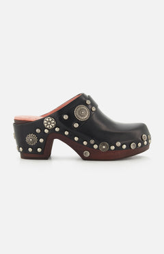 CHLOÉ Talis Studded Leather Clogs in black, featuring a slip-on design with a wooden heel and platform decorated with silver-tone floral and circular studs.