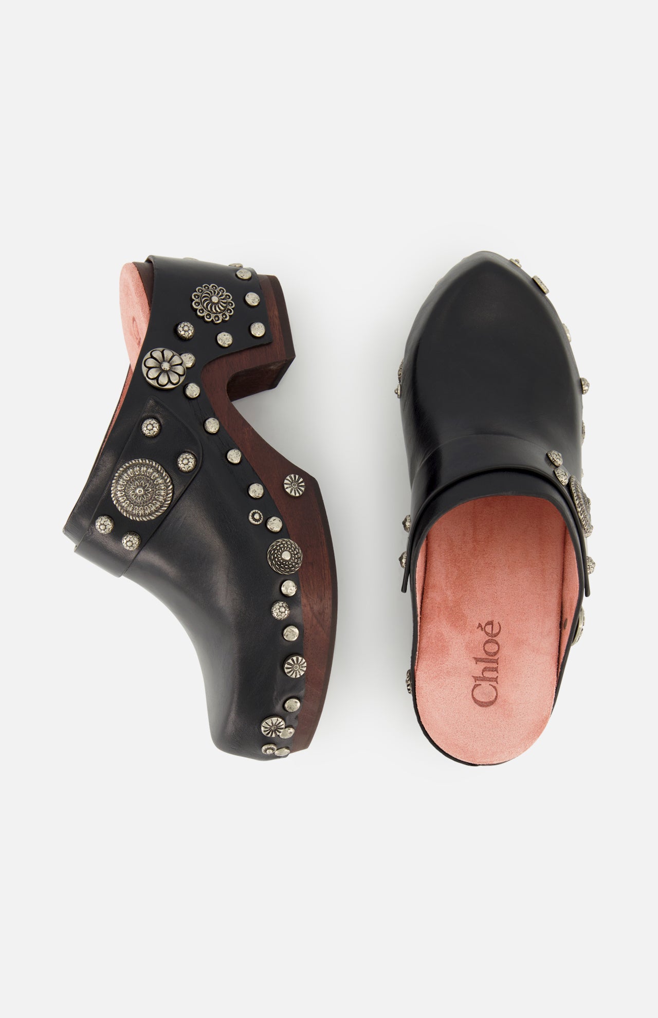 CHLOÉ Talis Studded Leather Clogs in black with wooden soles and decorative silver-tone studs, shown from the side and top in a slip-on design.