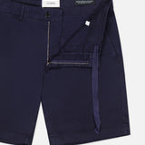 CLOSED Classic Chino Shorts in navy stretch cotton twill feature a zipper fly, button closure, belt loops, and an interior waist tie, with a partially unzipped design highlighting the inside details.