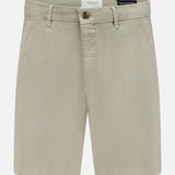 The CLOSED Classic Chino Shorts in beige are made from stretch cotton twill with belt loops, side pockets, and a front button and zip closure, shown against a white background.