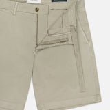 CLOSED Classic Chino Shorts in beige stretch cotton twill, featuring a zipper fly and button closure. Partially unzipped to show the inner waistband and pocket lining, shorts are laid flat on a white background.