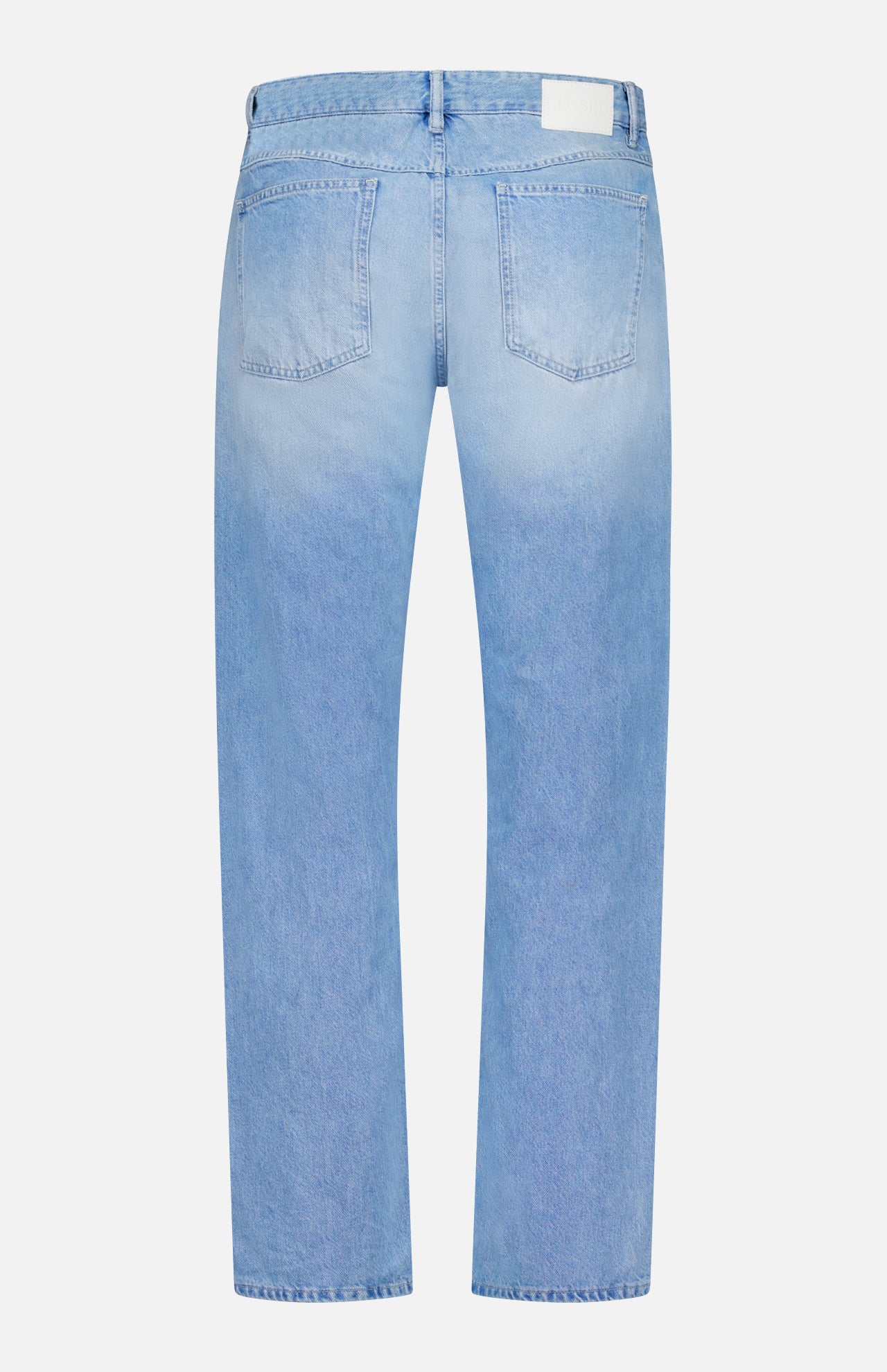 The back view of the CLOSED Cooper True Straight Leg Denim showcases light blue denim with two rear pockets, a waistband with belt loops, and a white rectangular patch on the right. Crafted from sustainable denim, these jeans feature subtle fading on the seat and thighs.