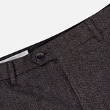 Close-up of the waistband and button of the Fairport Relaxed Trouser Pant by CLOSED in dark brown, showcasing the textured wool-blend fabric and part of the zipper fly. These high waist, straight leg pants emphasize meticulous tailoring and refined style.