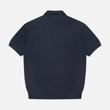 The CLOSED French Terry Johnny Collar Polo Shirt is shown from the back in navy blue, featuring a flat collar, ribbed hem, and short sleeves. The textured fabric stands out against the plain white background.