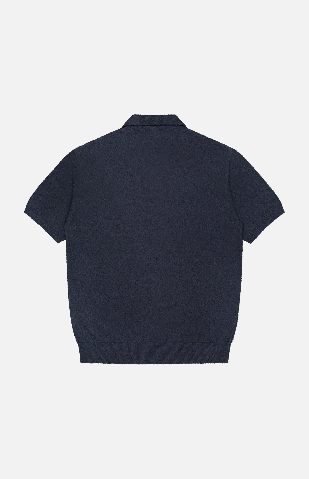 The CLOSED French Terry Johnny Collar Polo Shirt is shown from the back in navy blue, featuring a flat collar, ribbed hem, and short sleeves. The textured fabric stands out against the plain white background.
