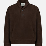 The Shawl Collar Sweater by CLOSED is a dark brown women’s pullover featuring long sleeves, a shawl collar with two buttons at the neck, a kangaroo pocket, and ribbed cuffs and hem. The label inside the collar displays the CLOSED brand. This sweater is presented on a plain white background.