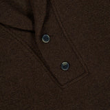 Close-up of the CLOSED Shawl Collar Sweater in chocolate brown, showcasing its textured finish, two black buttons near the collar, and a partially visible white tag with black text.