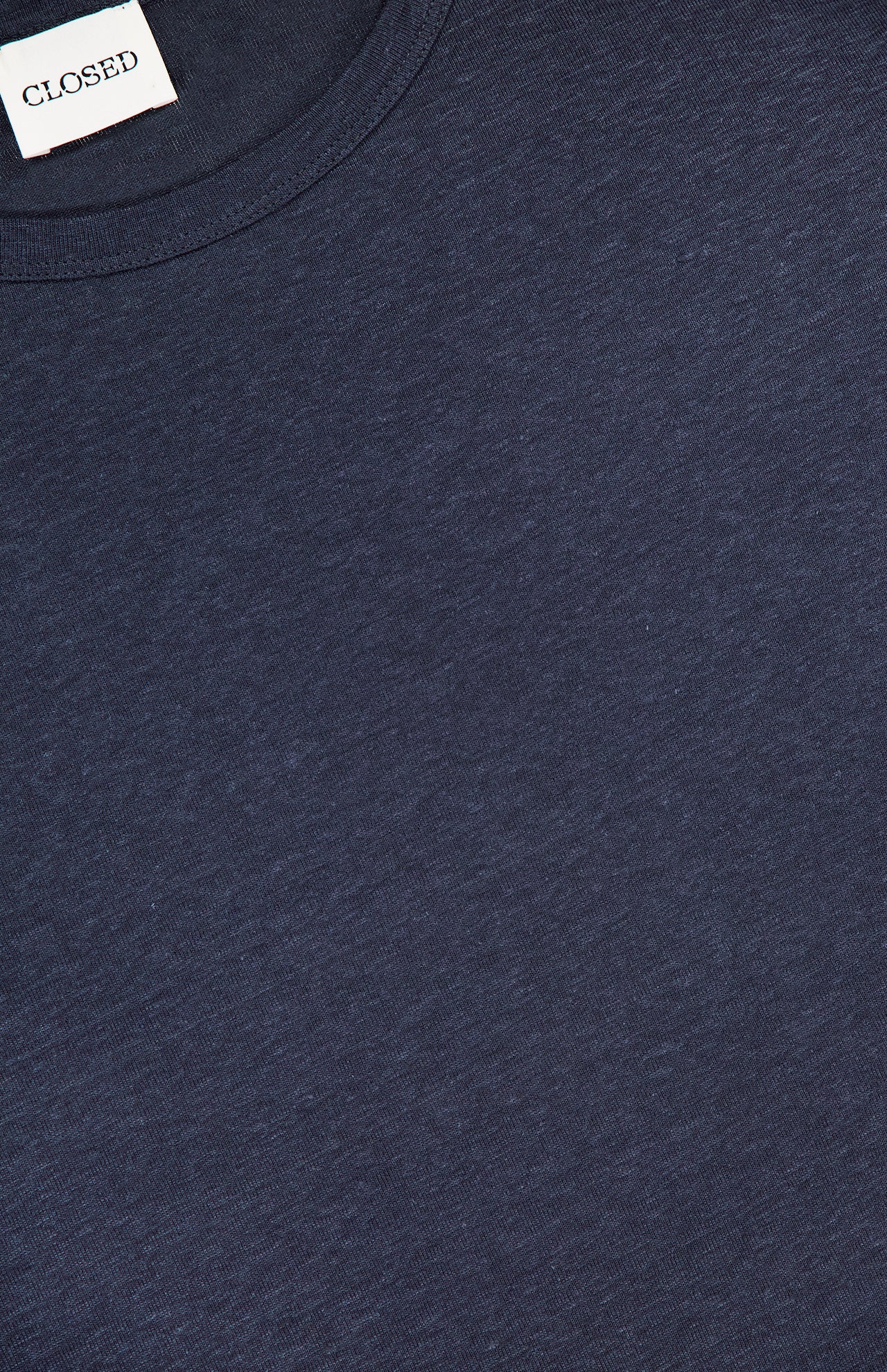 Close-up of a navy Long Sleeve T-shirt by CLOSED, featuring a round neckline and a small white "CLOSED" label. This lightweight tee combines comfort and style for everyday wear.