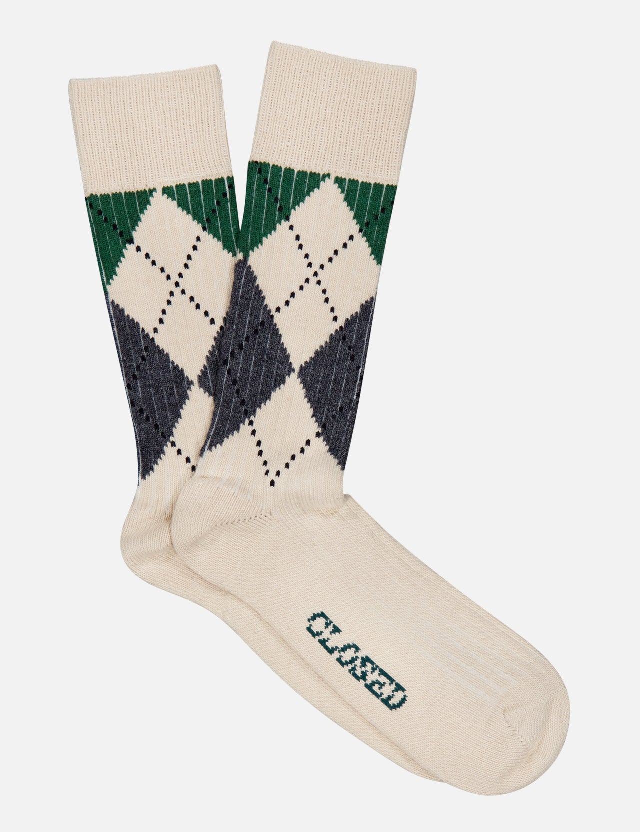 A pair of CLOSED Argyle Socks in a cream color, featuring a green and navy argyle pattern near the top and the word “CLOSED” printed in green on the sole.