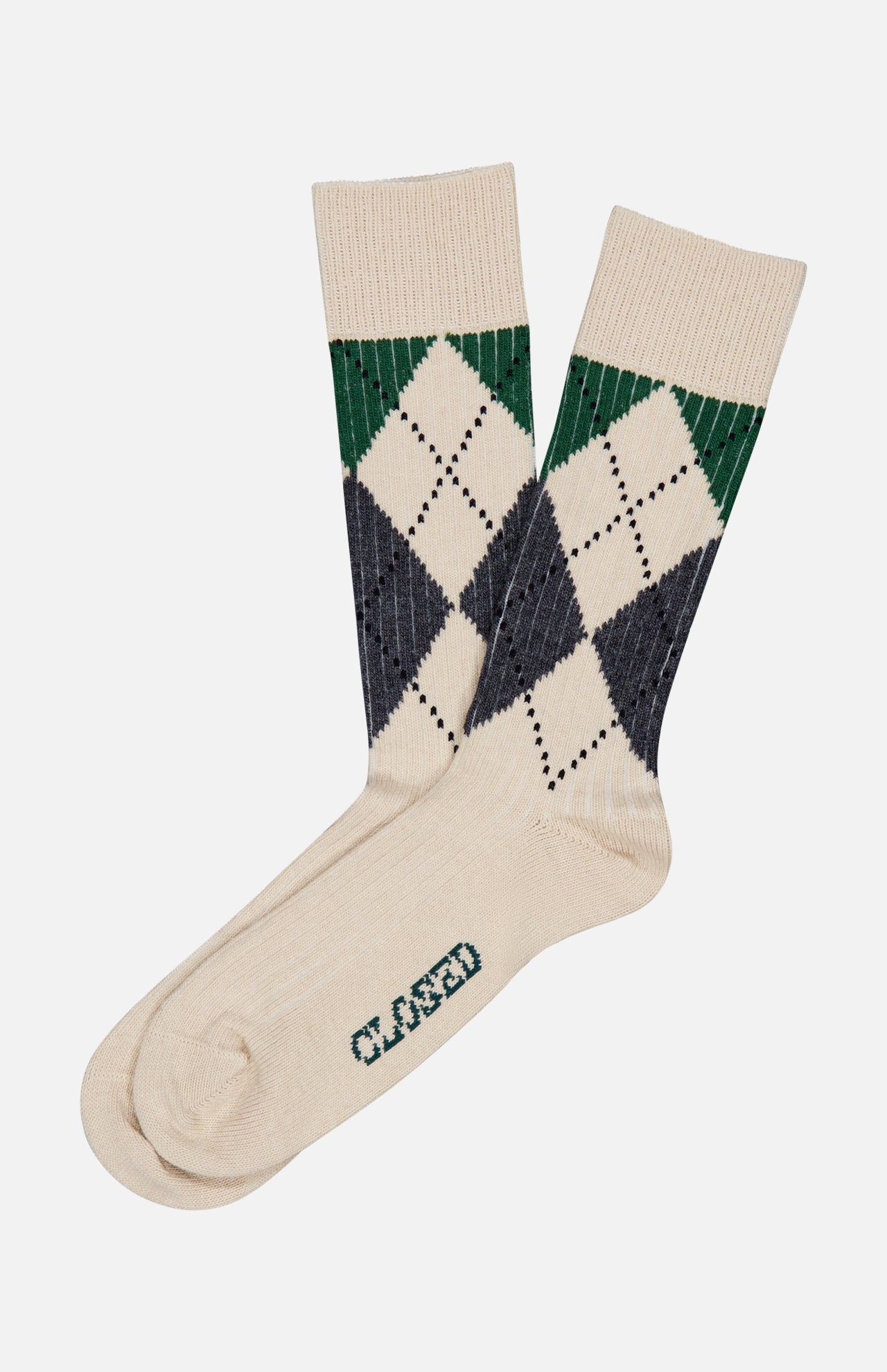 A pair of CLOSED Argyle Socks in a cream color, featuring a green and navy argyle pattern and “CLOSED” printed on the sole.