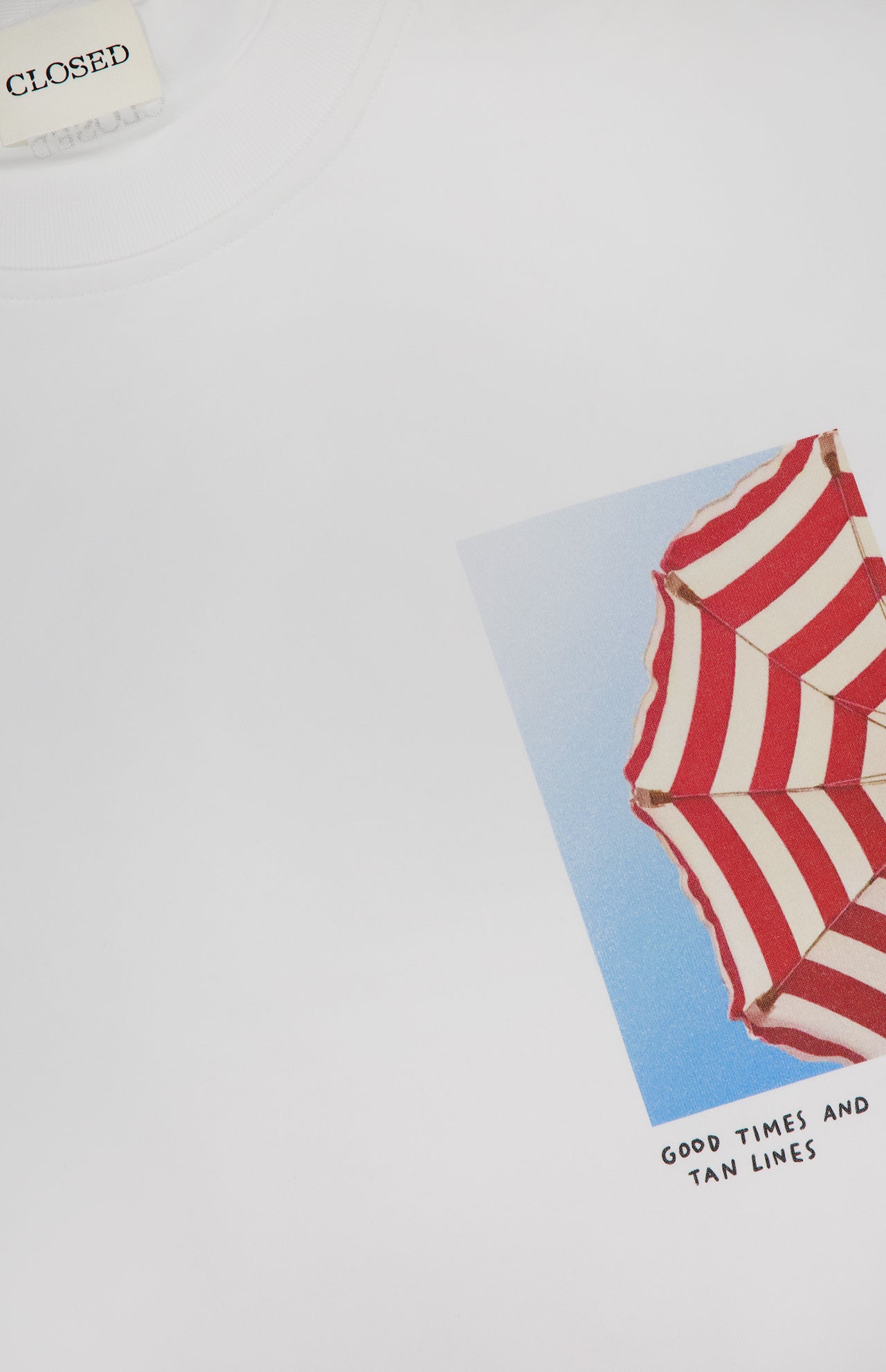 The CLOSED Printed Graphic T-Shirt is made from organic cotton and showcases a photo print of a red-and-white striped beach umbrella against a blue sky, with "GOOD TIMES AND TAN LINES" below the image.