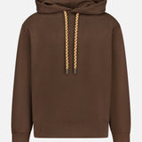 The CLOSED Retro Hoodie Sweatshirt in espresso brown showcases a classic drawstring hood with yellow and white patterned drawcords. Crafted from 100% cotton, it features a convenient front pocket and is photographed against a plain white background.