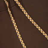 Close-up of the Retro Hoodie Sweatshirt by CLOSED in espresso brown, featuring a drawstring hood with yellow, white, and black houndstooth-patterned drawstrings, shown against the matching 100% cotton fabric of the hood.