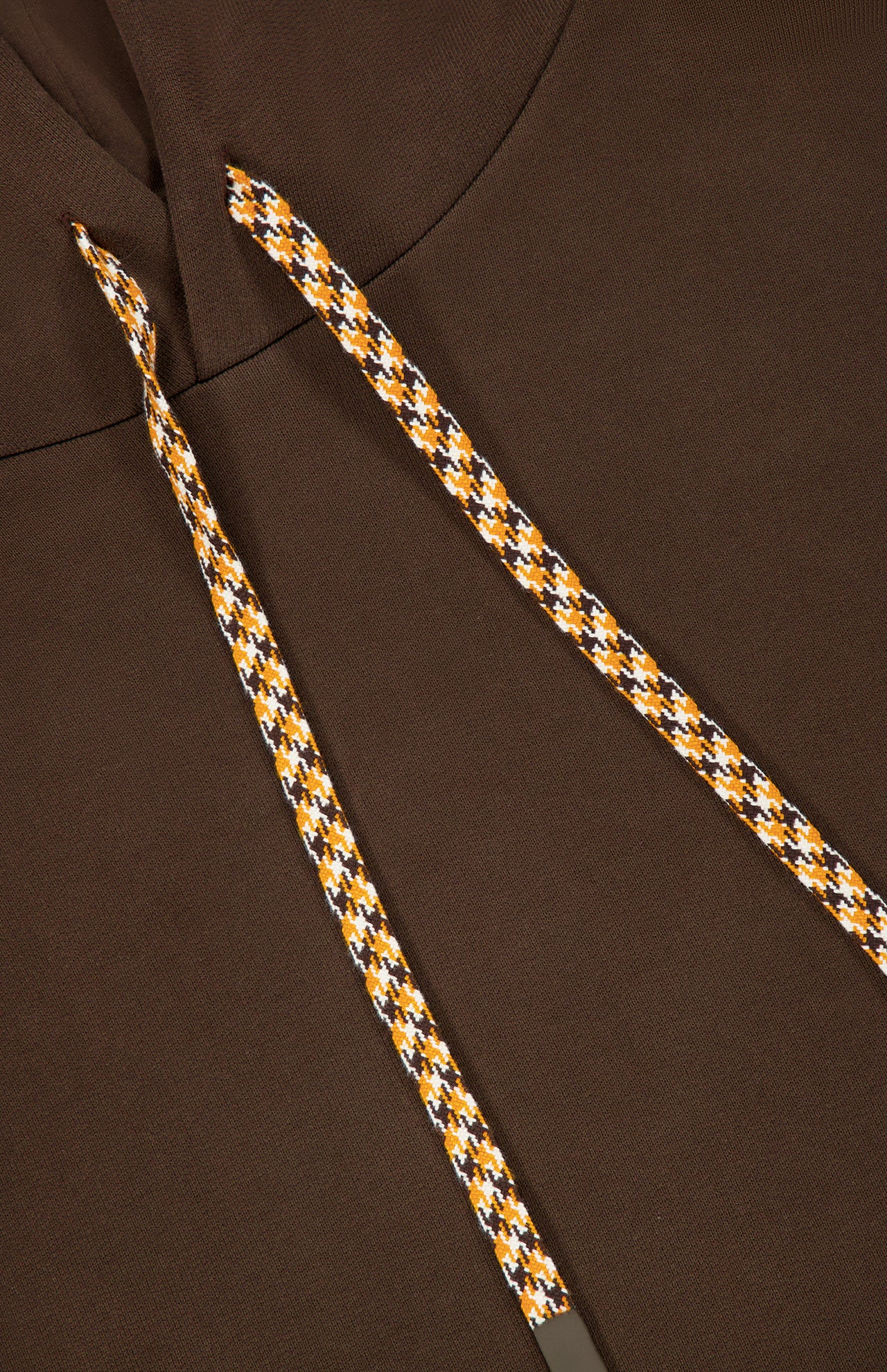 Close-up of the Retro Hoodie Sweatshirt by CLOSED in espresso brown, featuring a drawstring hood with yellow, white, and black houndstooth-patterned drawstrings, shown against the matching 100% cotton fabric of the hood.