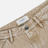 Close-up of the Shoreham Wide Pant by CLOSED in beige denim, featuring belt loops, a button closure, and a white label inside the waistband that reads “CLOSED Made in Italy,” shown against a white background. These wide fit jeans exemplify quality Italian craftsmanship and timeless style.