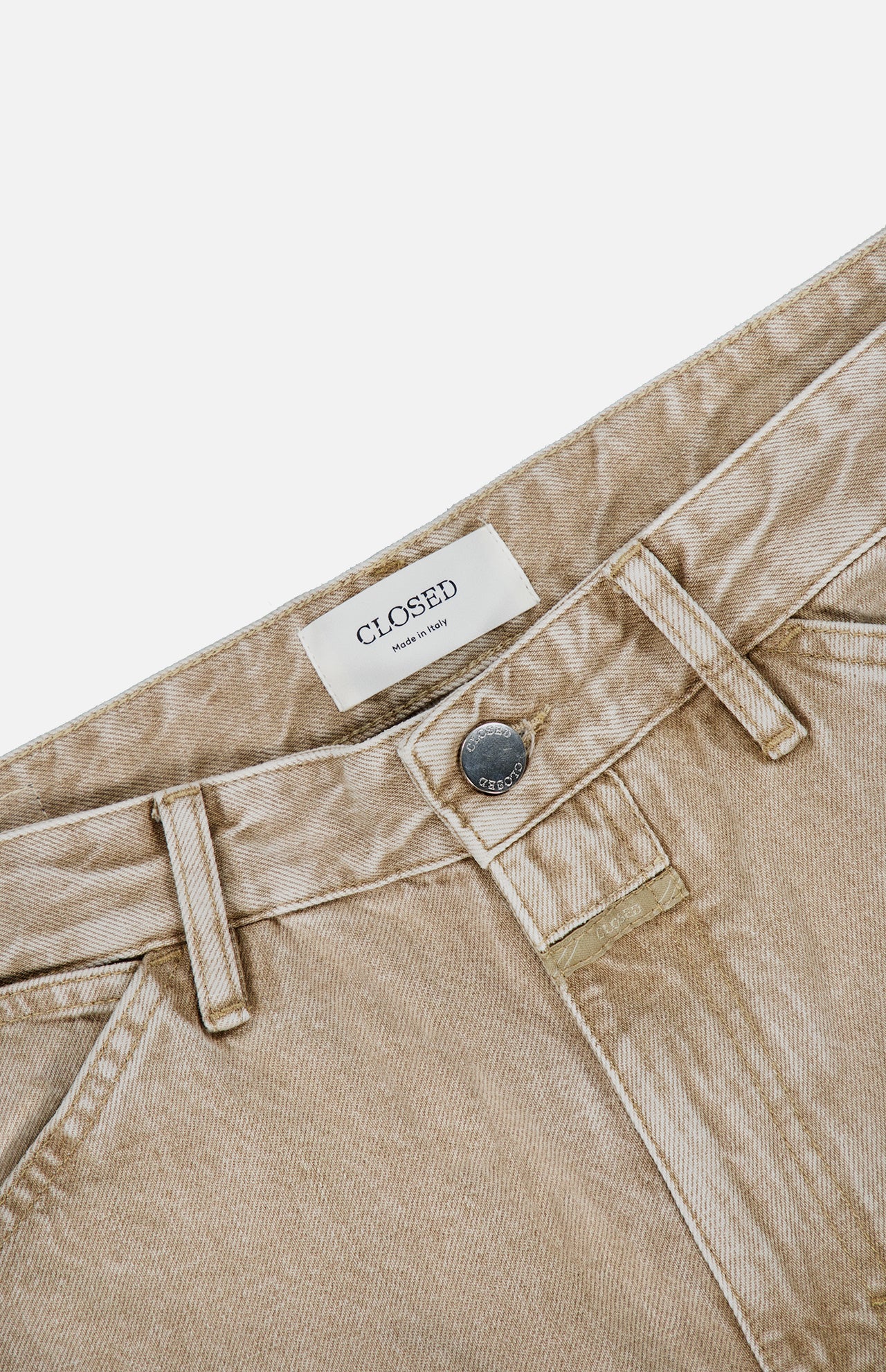 Close-up of the Shoreham Wide Pant by CLOSED in beige denim, featuring belt loops, a button closure, and a white label inside the waistband that reads “CLOSED Made in Italy,” shown against a white background. These wide fit jeans exemplify quality Italian craftsmanship and timeless style.