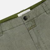 Close-up of the waistband and upper front of CLOSED's Toledo Tapered Trouser Pants in olive green cotton, featuring belt loops, button closure, visible stitching, and a partially visible white label.