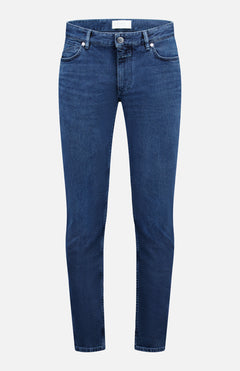 The Unity Slim Jean by CLOSED is a pair of classic dark blue denim jeans featuring a slim fit, front button and zipper closure, and five pockets. Made in Italy, they are displayed against a white background.