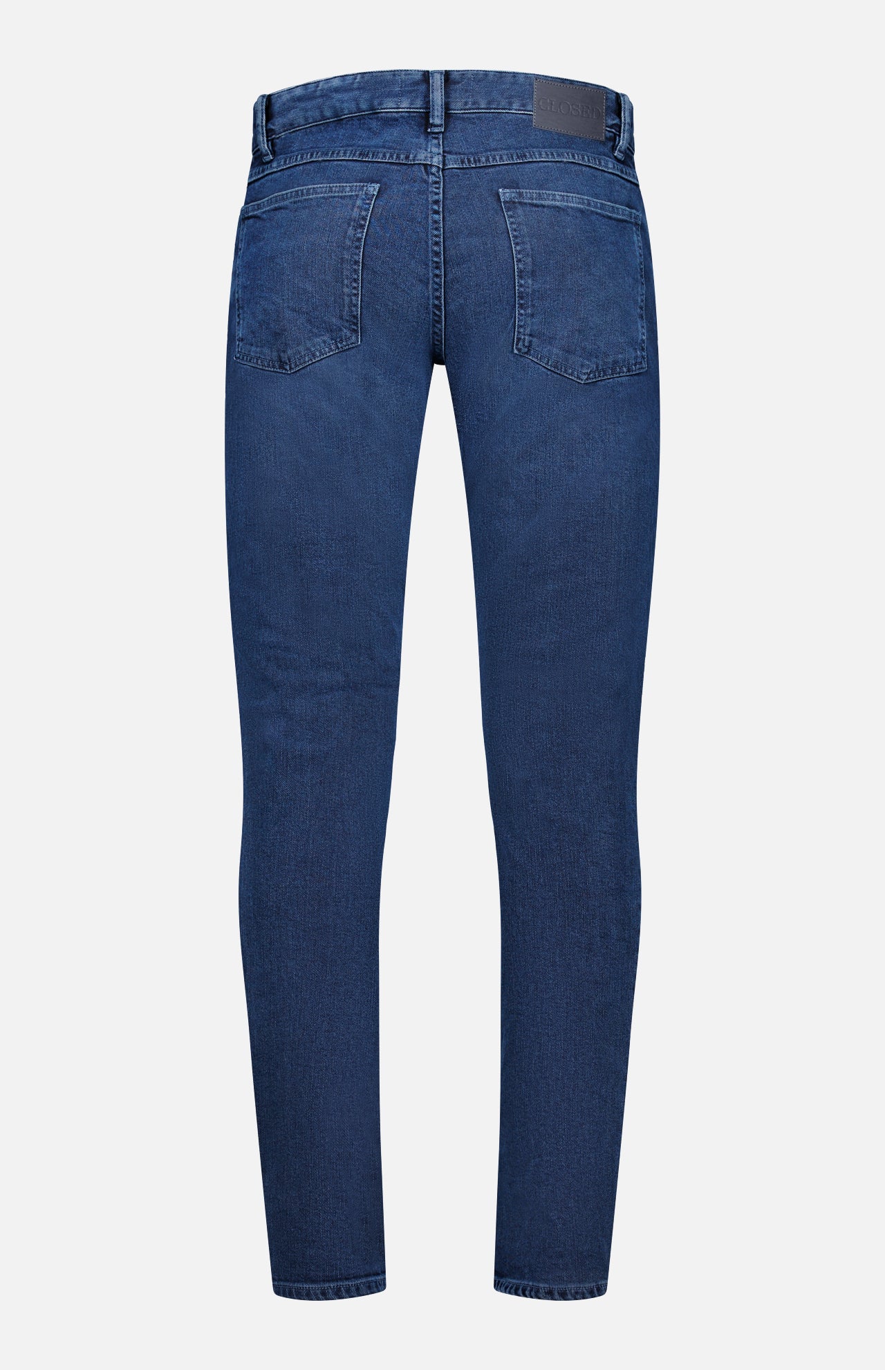 Back view of the CLOSED Unity Slim Jean in dark blue denim, featuring a slim fit, two rear pockets, belt loops, and a black patch on the waistband. The jeans are displayed against a plain white background.