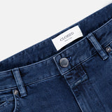 Close-up of the top part of CLOSED Unity Slim Jean in dark blue denim, featuring a metal button, belt loops, front pocket, and a white label with the CLOSED brand name stitched on the inside waistband. Expertly crafted from premium materials and made in Italy.