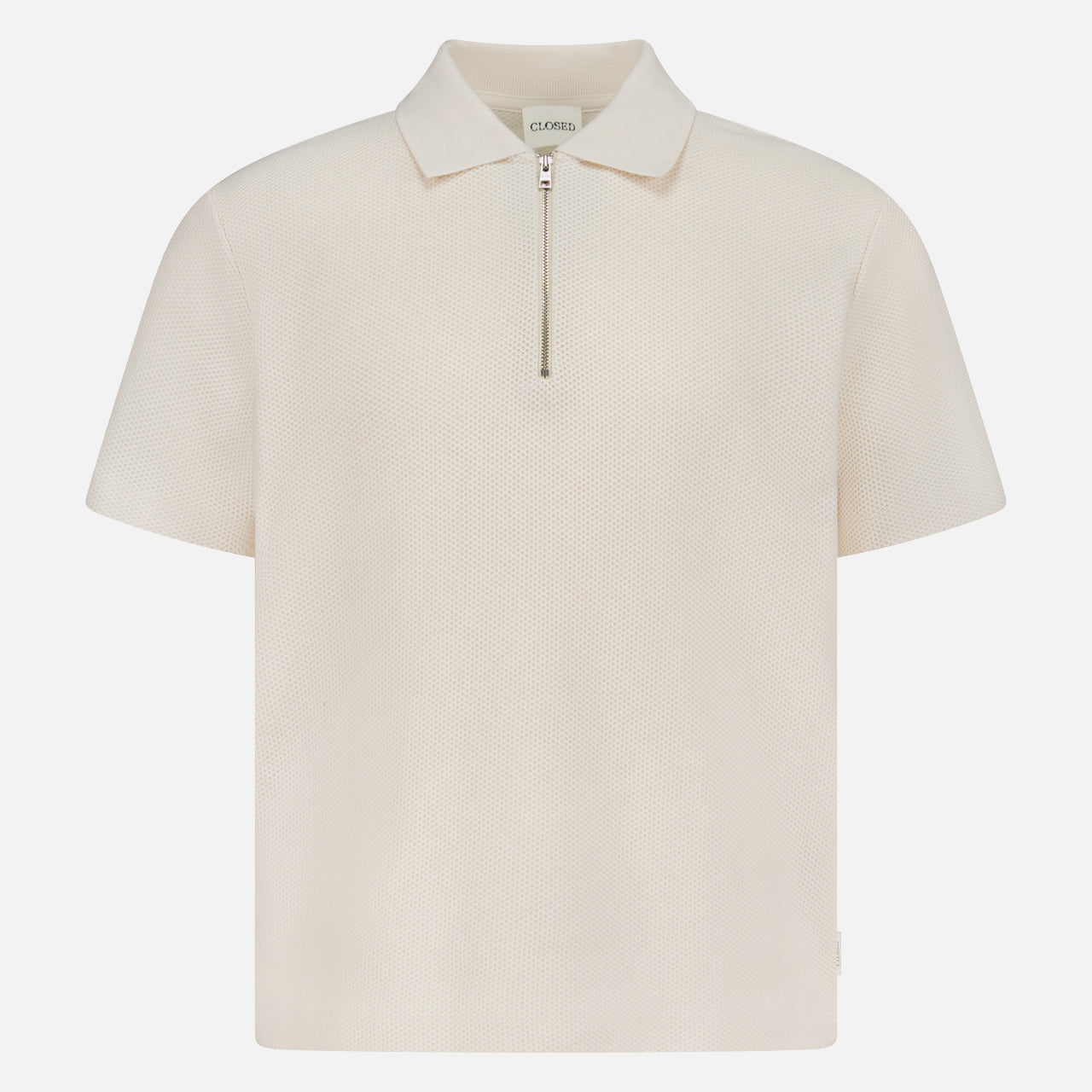 The CLOSED Zipped Neck Polo Shirt is a cream, short-sleeve polo crafted from textured cotton, featuring a collar and silver zip detail, shown on a plain white background.