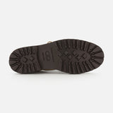 The image shows the bottom view of a COMMON PROJECTS Hiker Low Suede Piuma Boot in dark brown, featuring rugged tread patterns on the sole and the number 42 indicating the shoe size.
