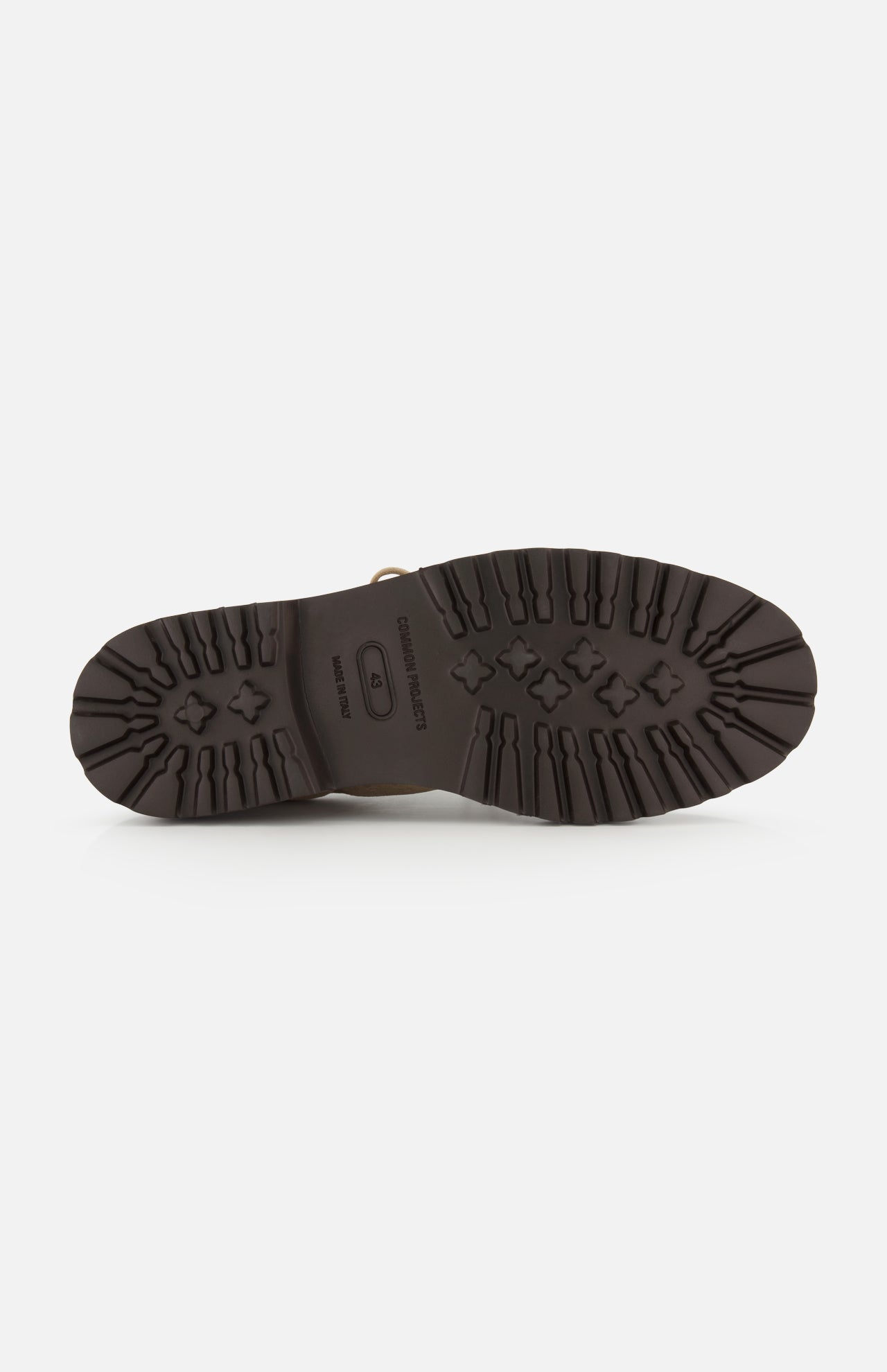 The image shows the bottom view of a COMMON PROJECTS Hiker Low Suede Piuma Boot in dark brown, featuring rugged tread patterns on the sole and the number 42 indicating the shoe size.