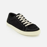 The COMMON PROJECTS Premium Skate In Nubuck Sneaker, a luxury black nubuck low-top with white laces and an off-white rubber sole, is displayed against a plain white background.