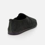 A single COMMON PROJECTS Suede Slipper Shoe in dark green suede with a black sole, shown from a rear side angle on a plain light gray background.
